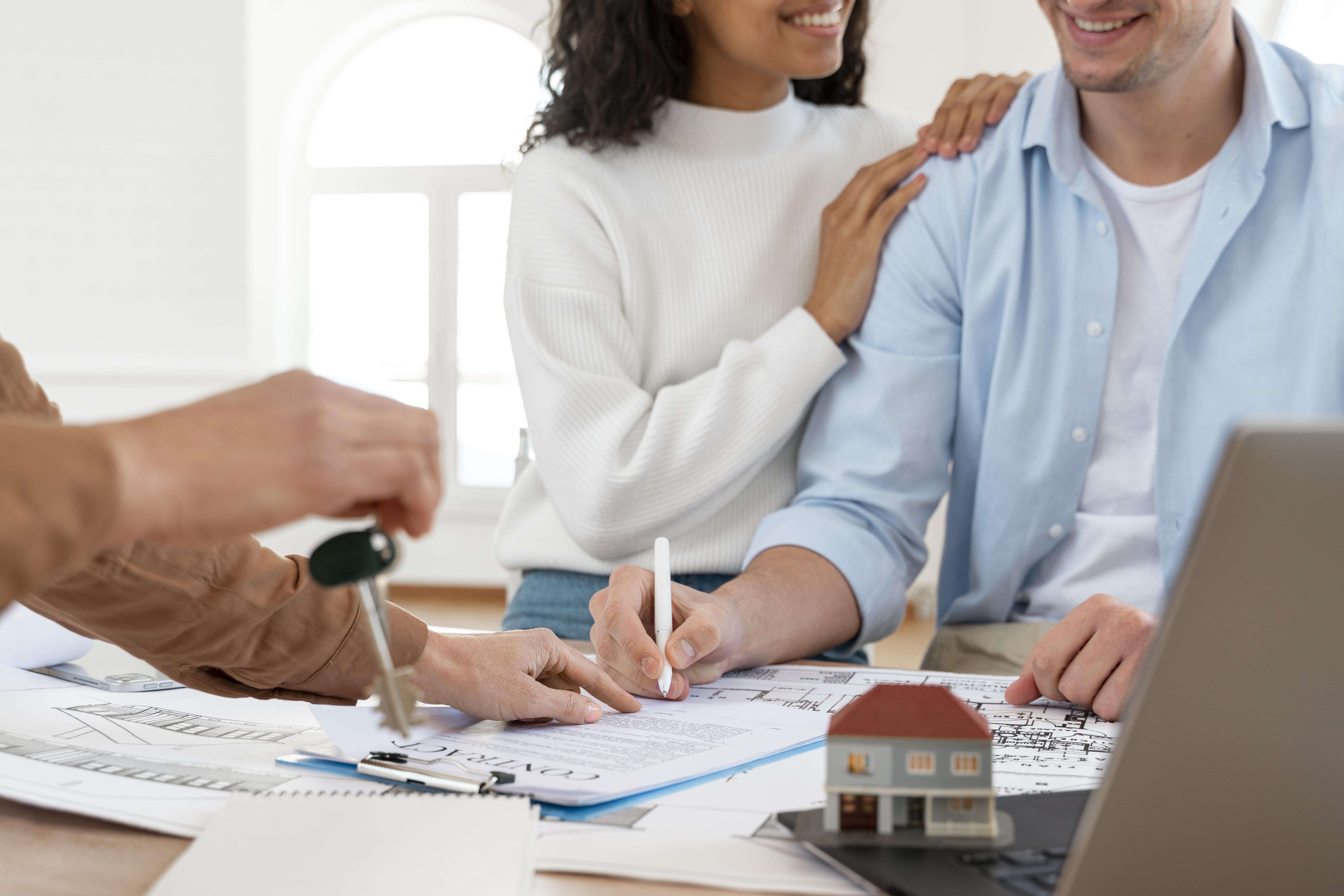 smiley-couple-signing-contract-new-house