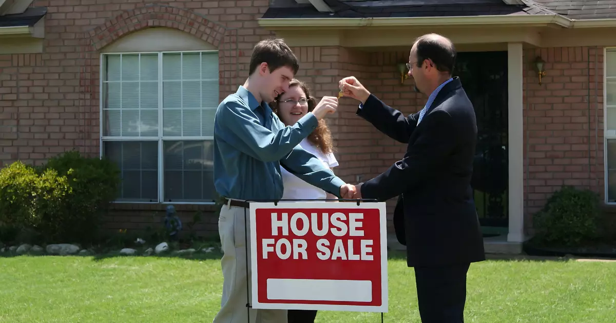 A group of people handing over a key to a house