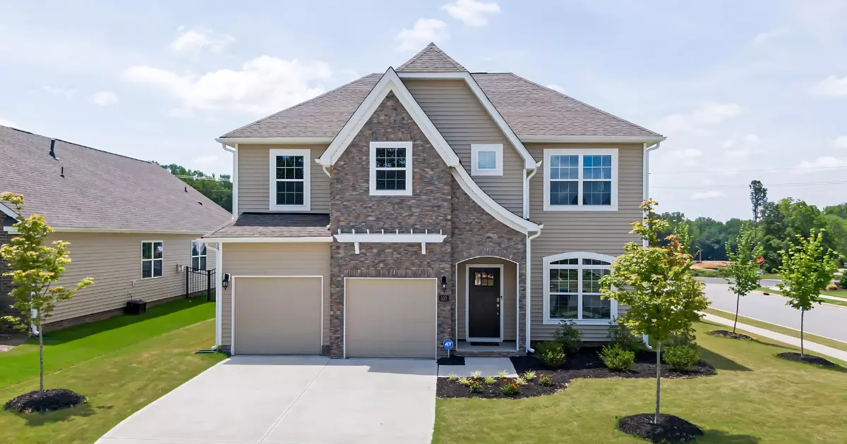 A house with a driveway and trees