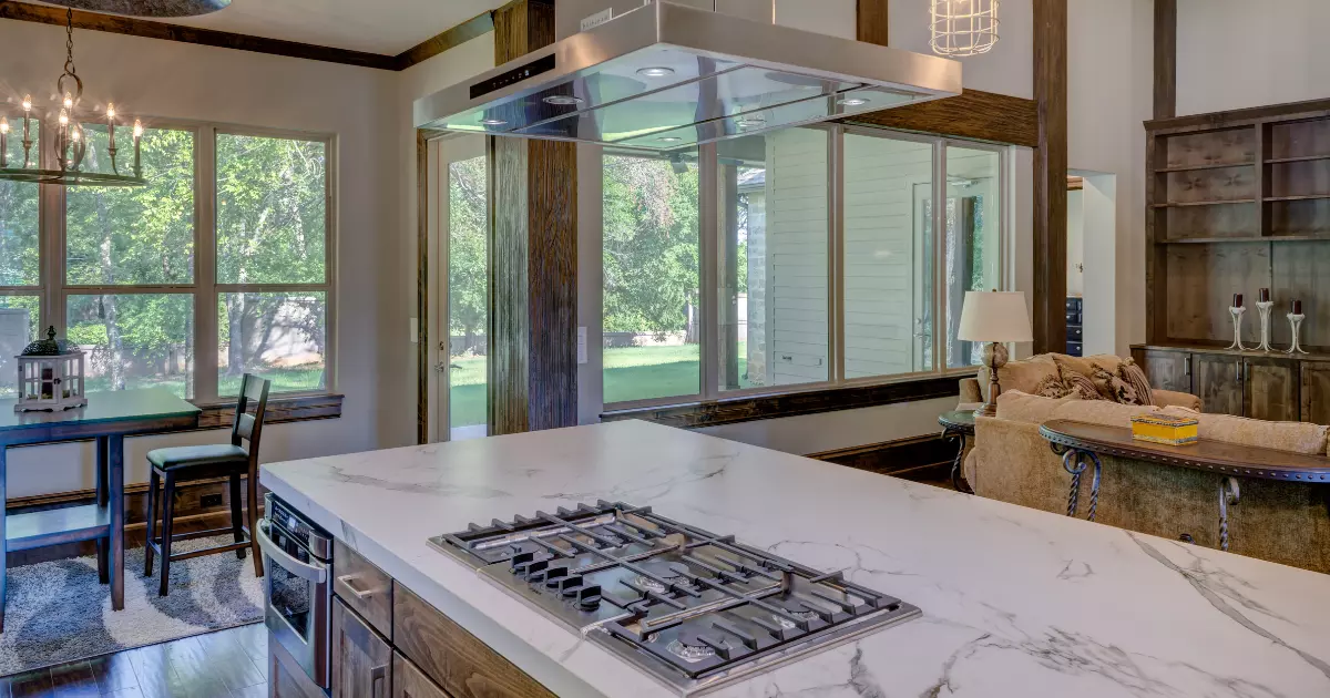 A kitchen with a marble counter top