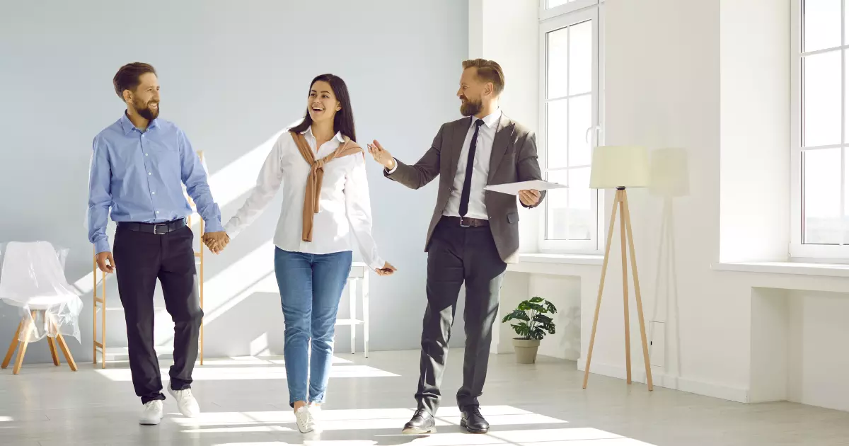 A group of people walking in a room 