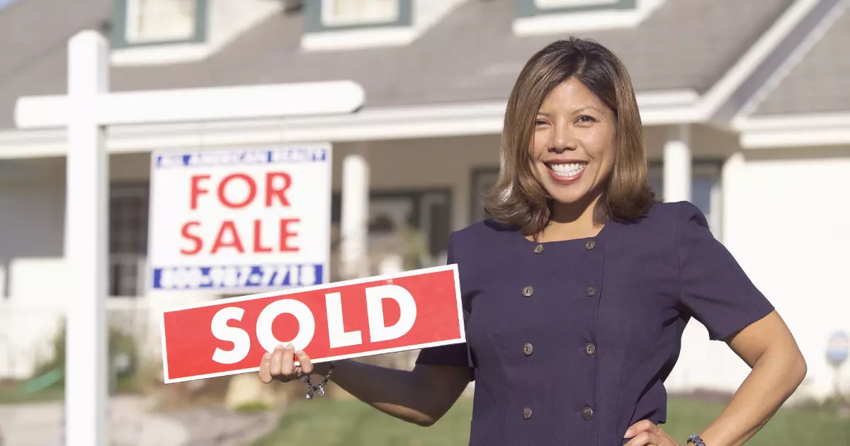 A person holding a sold out sign