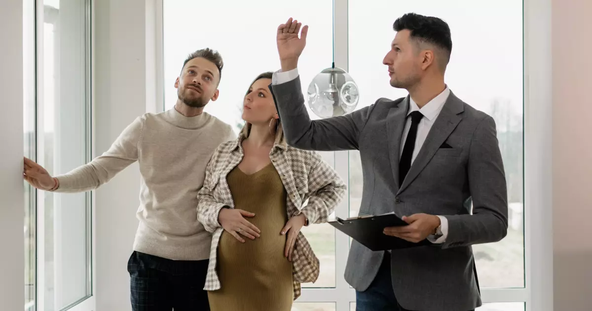 a real estate agent giving a house tour to a couple