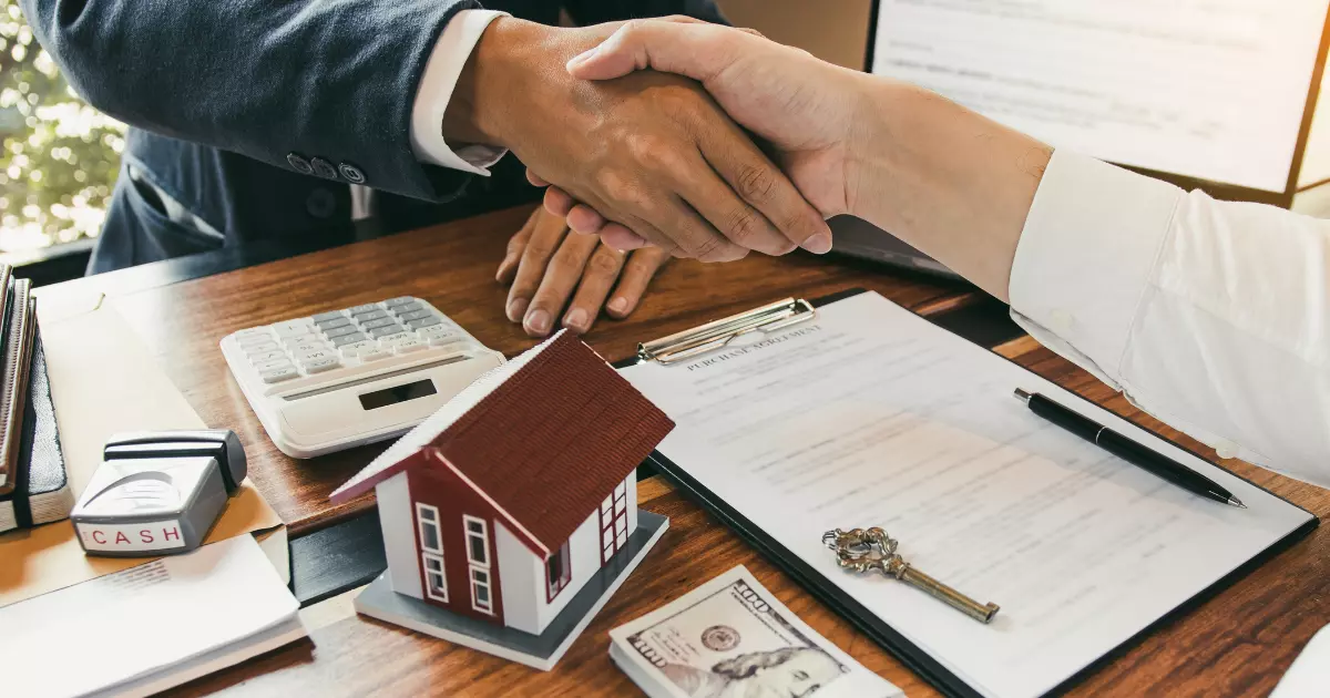 A handshake between a house and a key