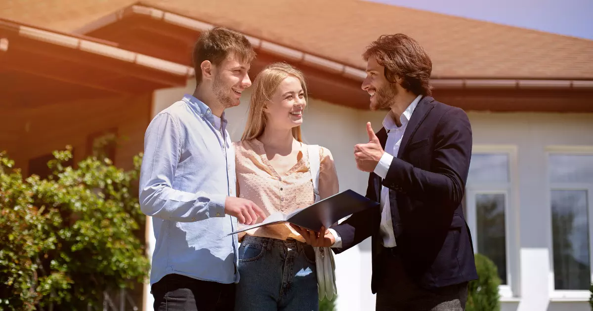 Couple consulting agent about property management service